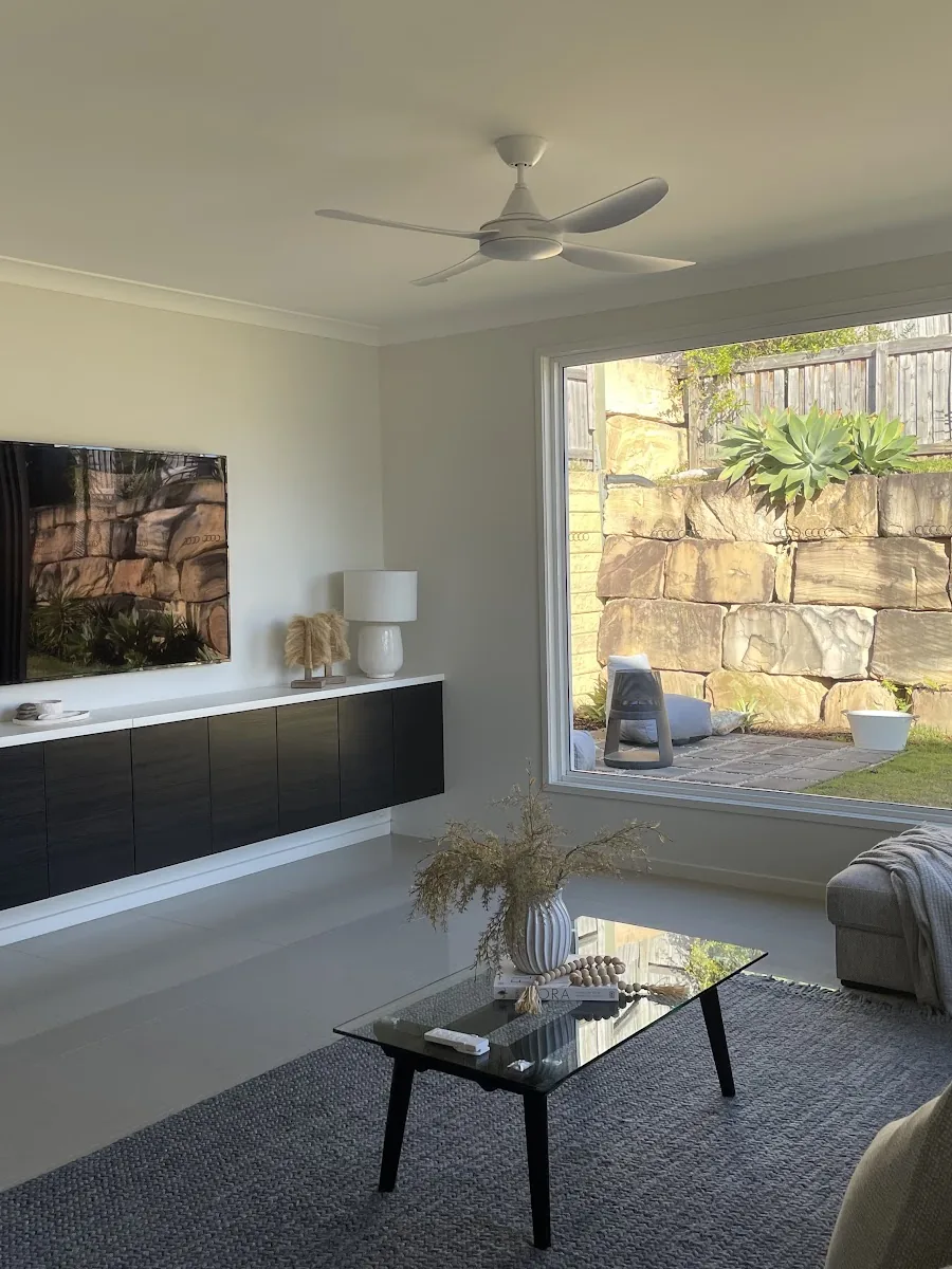 Living room with a new white ceiling fan and large picture window